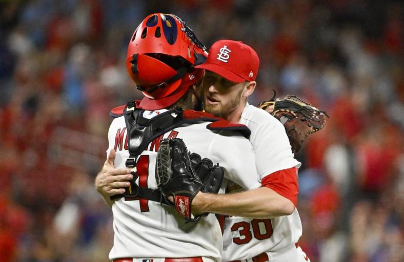 Aug 2, 2022; St. Louis, Missouri, USA;  St. Louis Cardinals relief pitcher Chris Stratton (30) celebrates with catcher Yadier Molina (4) after the Cardinals defeated the Chicago Cubs at Busch Stadium. Mandatory Credit: Jeff Curry-USA TODAY Sports