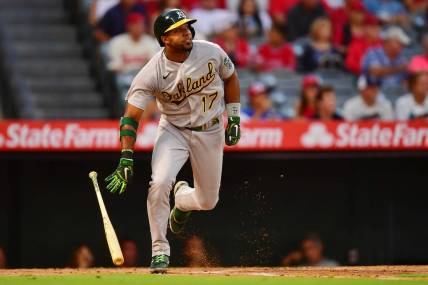 Aug 2, 2022; Anaheim, California, USA; Oakland Athletics shortstop Elvis Andrus (17) hits a single against the Los Angeles Angels during the fourth inning at Angel Stadium. Mandatory Credit: Gary A. Vasquez-USA TODAY Sports
