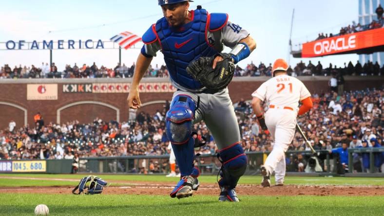 Aug 2, 2022; San Francisco, California, USA; Los Angeles Dodgers catcher Austin Barnes (15) chases down the ball after a wild pitch against the San Francisco Giants during the fourth inning at Oracle Park. Mandatory Credit: Kelley L Cox-USA TODAY Sports