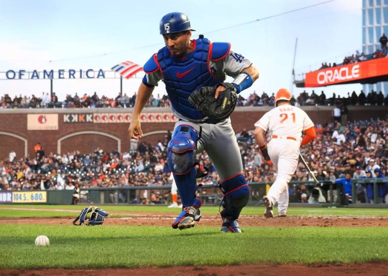 Aug 2, 2022; San Francisco, California, USA; Los Angeles Dodgers catcher Austin Barnes (15) chases down the ball after a wild pitch against the San Francisco Giants during the fourth inning at Oracle Park. Mandatory Credit: Kelley L Cox-USA TODAY Sports