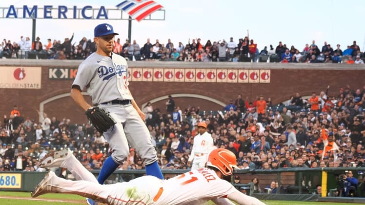 Aug 2, 2022; San Francisco, California, USA; San Francisco Giants right fielder Luis Gonzalez (51) scores ahead of Los Angeles Dodgers starting pitcher Tyler Anderson (31) on a wild pitch during the fourth inning at Oracle Park. Mandatory Credit: Kelley L Cox-USA TODAY Sports
