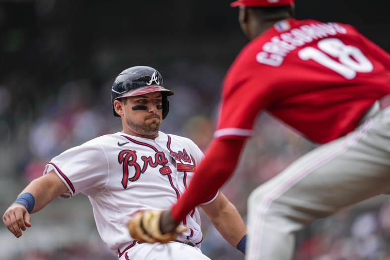 Aug 3, 2022; Cumberland, Georgia, USA; Atlanta Braves third baseman Austin Riley (27) is tagged out at third base by Philadelphia Phillies shortstop Didi Gregorius (18) during the second inning at Truist Park. Mandatory Credit: Dale Zanine-USA TODAY Sports