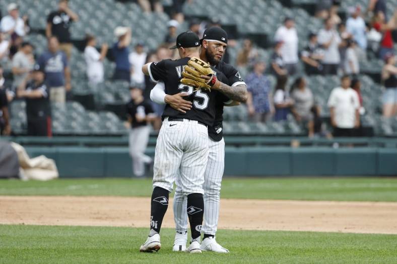 Aug 3, 2022; Chicago, Illinois, USA; Chicago White Sox designated hitter Andrew Vaughn (25) and third baseman Yoan Moncada (10) celebrate their win against the Kansas City Royals at Guaranteed Rate Field. Mandatory Credit: Kamil Krzaczynski-USA TODAY Sports