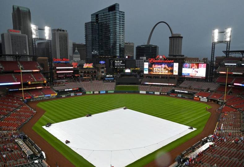 Aug 3, 2022; St. Louis, Missouri, USA;  Rain falls as the tarp covers the field before a game between the St. Louis Cardinals and the Chicago Cubs at Busch Stadium. Mandatory Credit: Jeff Curry-USA TODAY Sports