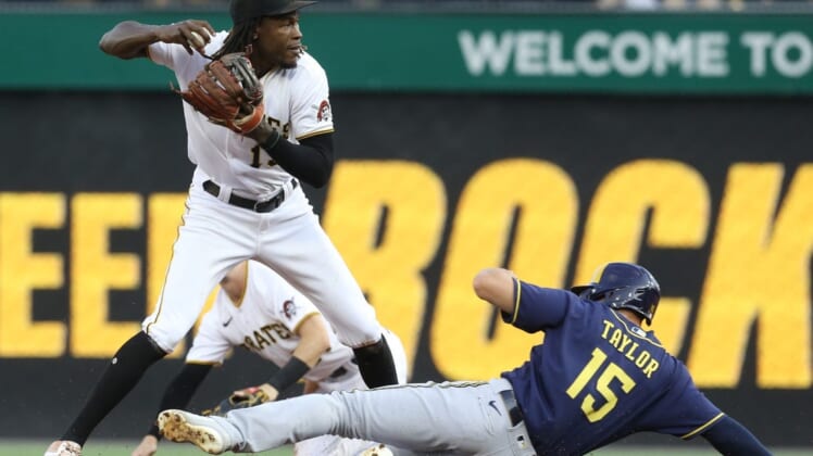 Aug 3, 2022; Pittsburgh, Pennsylvania, USA;  Pittsburgh Pirates shortstop Oneil Cruz (15) looks to throw to first base after a force out of Milwaukee Brewers center fielder Tyrone Taylor (15) at second base during the second inning at PNC Park. Mandatory Credit: Charles LeClaire-USA TODAY Sports