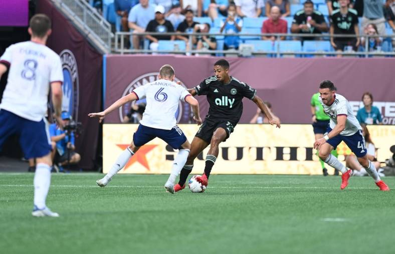 Aug 3, 2022; Charlotte, North Carolina, USA; Charlotte FC attacker McKinze Gaines (17) goes around D.C. United midfielder Russell Canouse (6) in the first half at Bank of America Stadium. Mandatory Credit: Griffin Zetterberg-USA TODAY Sports