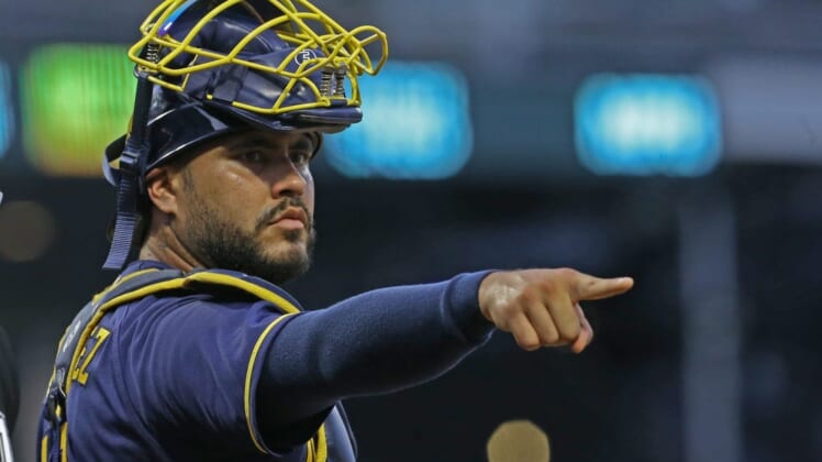 Aug 3, 2022; Pittsburgh, Pennsylvania, USA;  Milwaukee Brewers catcher Omar Narvaez (10) gestures to the Brewers dugout from behind home plate against the Pittsburgh Pirates during the fourth inning at PNC Park. Mandatory Credit: Charles LeClaire-USA TODAY Sports