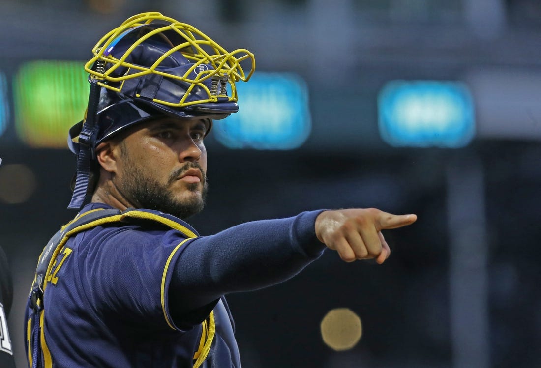 Aug 3, 2022; Pittsburgh, Pennsylvania, USA;  Milwaukee Brewers catcher Omar Narvaez (10) gestures to the Brewers dugout from behind home plate against the Pittsburgh Pirates during the fourth inning at PNC Park. Mandatory Credit: Charles LeClaire-USA TODAY Sports