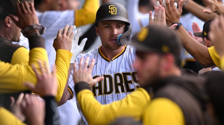 Aug 3, 2022; San Diego, California, USA; San Diego Padres designated hitter Brandon Drury (center) is congratulated in the dugout after hitting a grand slam home run during the first inning against the Colorado Rockies at Petco Park. Mandatory Credit: Orlando Ramirez-USA TODAY Sports