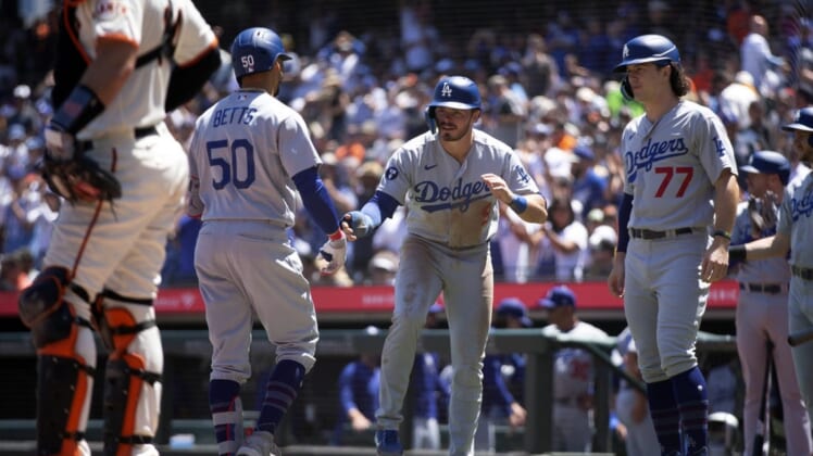 Aug 4, 2022; San Francisco, California, USA; Los Angeles Dodgers right fielder Mookie Betts (50) is greeted by teammates Gavin Lux (9) and James Outman (77) after hitting a three-run home run against the San Francisco Giants during the fourth inning at Oracle Park. Mandatory Credit: D. Ross Cameron-USA TODAY Sports