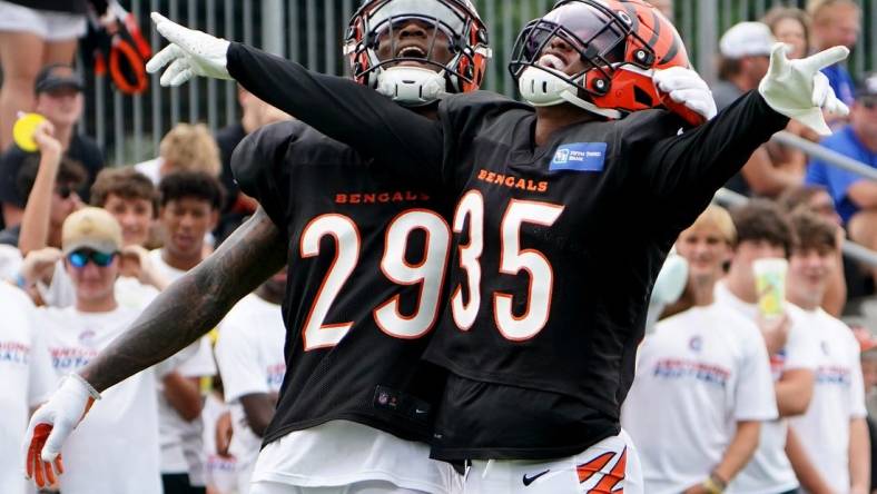 Aug 4, 2022; Cincinnati, OH, USA; Cincinnati Bengals cornerback Jalen Davis (35) celebrates a pass defense with Cincinnati Bengals cornerback Cam Taylor-Britt (29) during Cincinnati Bengals training camp practice, Thursday, Aug. 4, 2022, at the Paul Brown Stadium practice fields in Cincinnati.  Mandatory Credit: Kareem Elgazzar-USA TODAY Sports