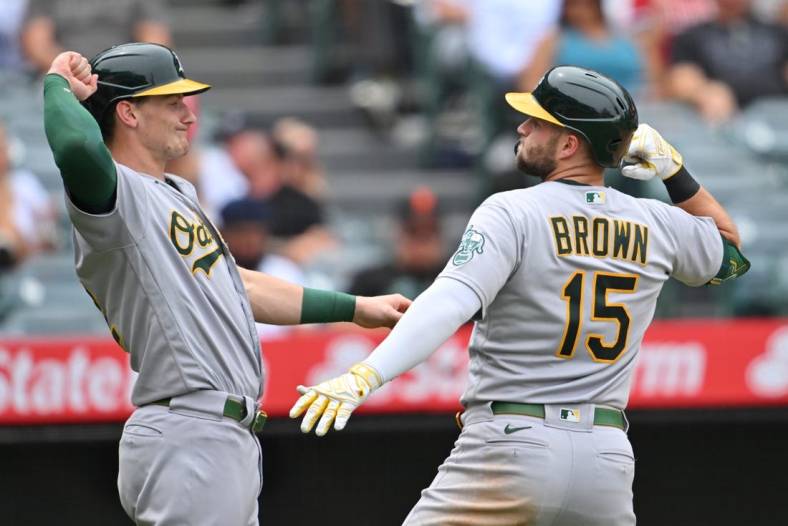 Aug 4, 2022; Anaheim, California, USA;  Oakland Athletics first baseman Seth Brown (15) is congratulated by designated hitter Sean Murphy (12) after hitting a two run home run in the third inning against the Los Angeles Angels at Angel Stadium. Mandatory Credit: Jayne Kamin-Oncea-USA TODAY Sports