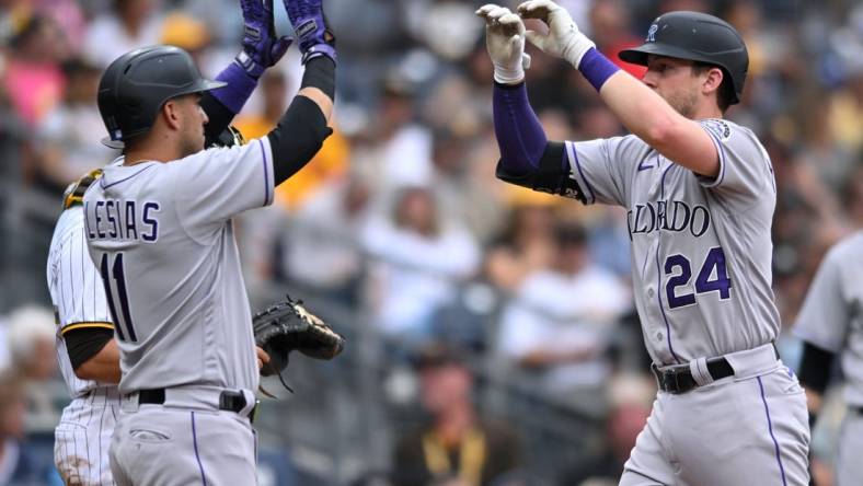 Aug 4, 2022; San Diego, California, USA; Colorado Rockies second baseman Ryan McMahon (24) is congratulated by designated hitter Jose Iglesias (11) after hitting a three-run home run against the San Diego Padres during the fifth inning at Petco Park. Mandatory Credit: Orlando Ramirez-USA TODAY Sports