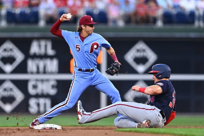 Aug 4, 2022; Philadelphia, Pennsylvania, USA; Philadelphia Phillies infielder Bryson Stott (5) attempts to turn a double play over Washington Nationals first baseman Luke Voit (34) in the first inning at Citizens Bank Park. Mandatory Credit: Kyle Ross-USA TODAY Sports