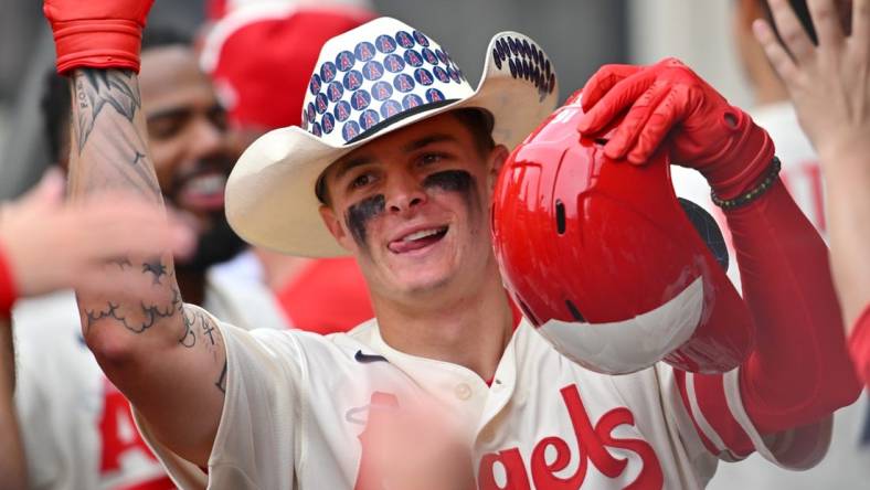 Aug 4, 2022; Anaheim, California, USA; Los Angeles Angels center fielder Mickey Moniak (16) is congratulated in the dugout after hitting his first major league home run in the ninth inning against the Oakland Athletics at Angel Stadium. Mandatory Credit: Jayne Kamin-Oncea-USA TODAY Sports