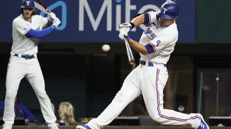 Aug 4, 2022; Arlington, Texas, USA; Texas Rangers shortstop Corey Seager (5) singles during the fifth inning against the Chicago White Sox at Globe Life Field. Mandatory Credit: Raymond Carlin III-USA TODAY Sports