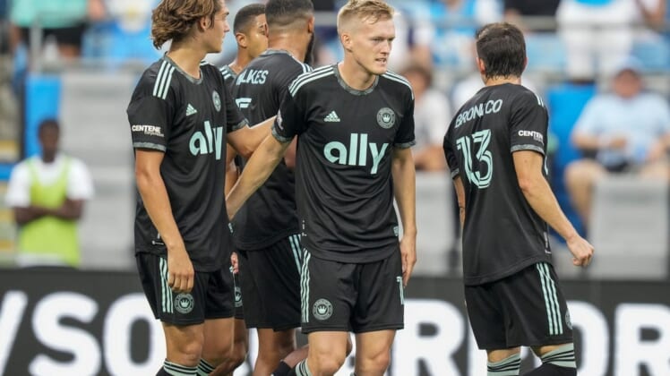 Aug 3, 2022; Charlotte, North Carolina, USA; Charlotte FC forward Karol Swiderski (11) gets congratulations on his first goal against the D.C. United from his teammates during the first half at Bank of America Stadium. Mandatory Credit: Jim Dedmon-USA TODAY Sports