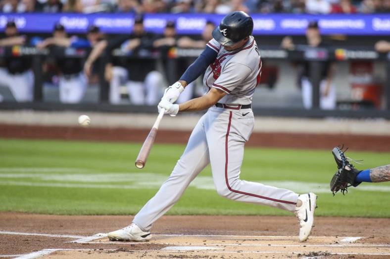 Aug 5, 2022; New York City, New York, USA;  Atlanta Braves first baseman Matt Olson (28) hits a double in the first inning against the New York Mets at Citi Field. Mandatory Credit: Wendell Cruz-USA TODAY Sports