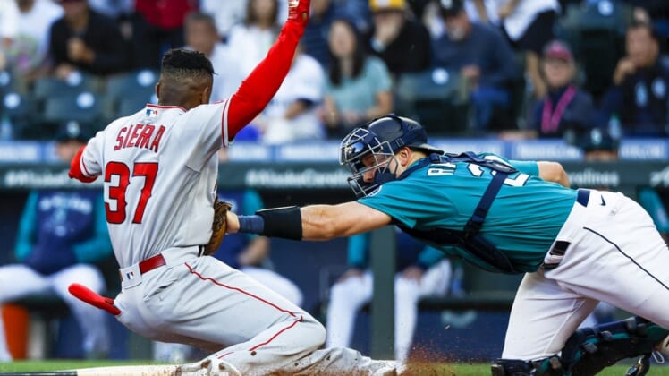 Aug 5, 2022; Seattle, Washington, USA; Seattle Mariners catcher Cal Raleigh (29) tags out Los Angeles Angels center fielder Magneuris Sierra (37) on an attempt to score on an inside-the-park homerun during the second inning at T-Mobile Park. Mandatory Credit: Joe Nicholson-USA TODAY Sports
