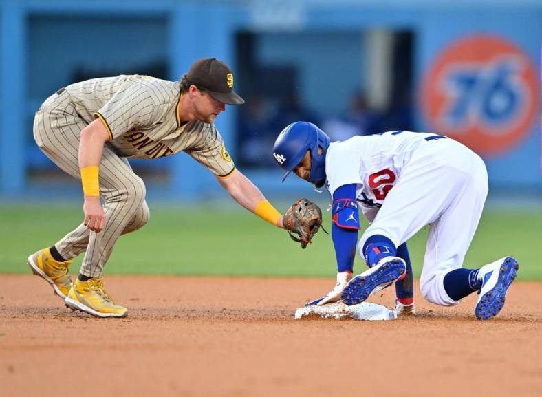 Aug 5, 2022; Los Angeles, California, USA; Los Angeles Dodgers right fielder Mookie Betts (50) is safe at second as he beats the tag by San Diego Padres second baseman Jake Cronenworth (9) in the first inning at Dodger Stadium. Mandatory Credit: Jayne Kamin-Oncea-USA TODAY Sports