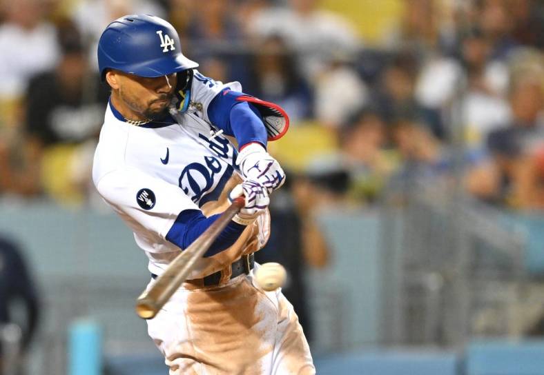 Aug 5, 2022; Los Angeles, California, USA; Los Angeles Dodgers right fielder Mookie Betts (50) singles in the sixth inning against the San Diego Padres at Dodger Stadium. Mandatory Credit: Jayne Kamin-Oncea-USA TODAY Sports