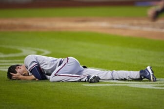 Aug 6, 2022; New York City, New York, USA; Atlanta Braves pitcher Max Fried (54) lies on the ground after a play against the New York Mets during the third inning at Citi Field. Mandatory Credit: Gregory Fisher-USA TODAY Sports