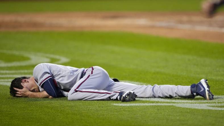 Aug 6, 2022; New York City, New York, USA; Atlanta Braves pitcher Max Fried (54) lies on the ground after a play against the New York Mets during the third inning at Citi Field. Mandatory Credit: Gregory Fisher-USA TODAY Sports