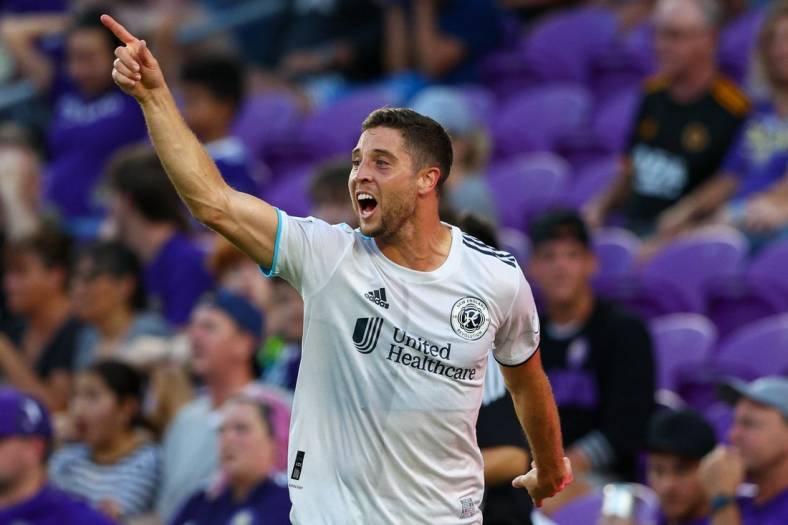 Aug 6, 2022; Orlando, Florida, USA;  New England Revolution midfielder Matt Polster (8) reacts after scoring a goal against Orlando City in the first half at Exploria Stadium. Mandatory Credit: Nathan Ray Seebeck-USA TODAY Sports