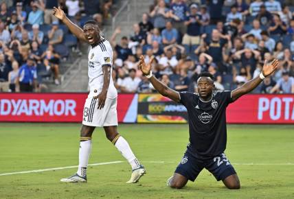 Aug 6, 2022; Kansas City, Kansas, USA; Sporting Kansas City forward William Agada (23) reacts after his header for a goal during the first half against Los Angeles Galaxy midfielder Marco Delgado (8) at Children's Mercy Park. Mandatory Credit: Peter Aiken-USA TODAY Sports