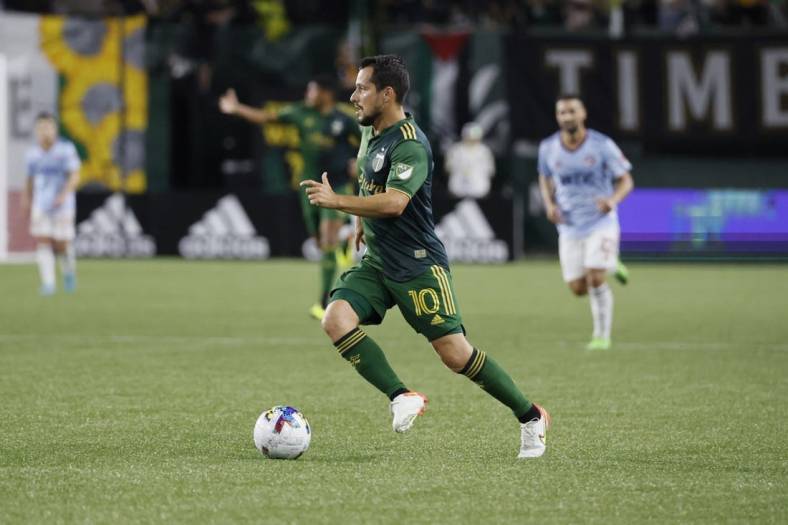 Aug 6, 2022; Portland, Oregon, USA; Portland Timbers midfielder Sebastian Blanco (10) carries the ball during the second half against the FC Dallas at Providence Park. Mandatory Credit: Soobum Im-USA TODAY Sports