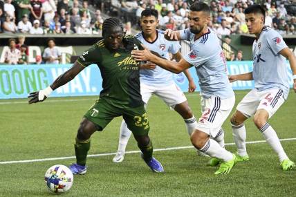 Aug 6, 2022; Portland, Oregon, USA; FC Dallas midfielder Sebastian Lletget (12) defends Portland Timbers forward Yimmi Chara (23) during the first half at Providence Park. The game ended tied 1-1. Mandatory Credit: Troy Wayrynen-USA TODAY Sports