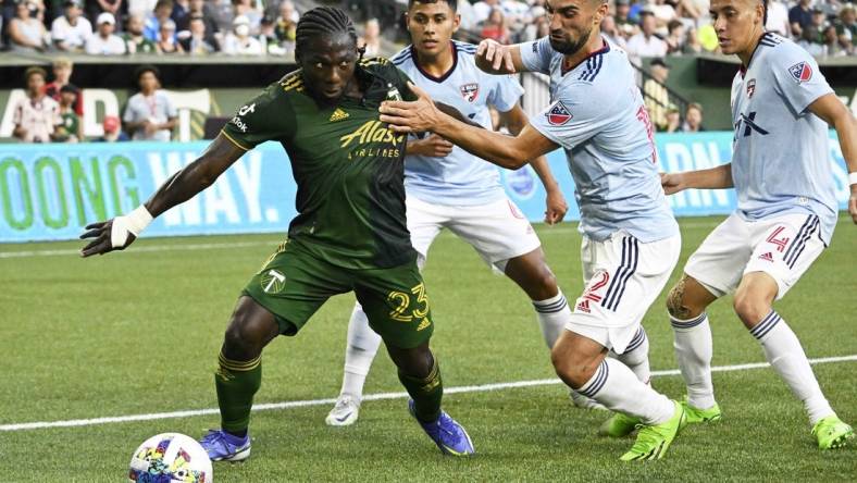 Aug 6, 2022; Portland, Oregon, USA; FC Dallas midfielder Sebastian Lletget (12) defends Portland Timbers forward Yimmi Chara (23) during the first half at Providence Park. The game ended tied 1-1. Mandatory Credit: Troy Wayrynen-USA TODAY Sports