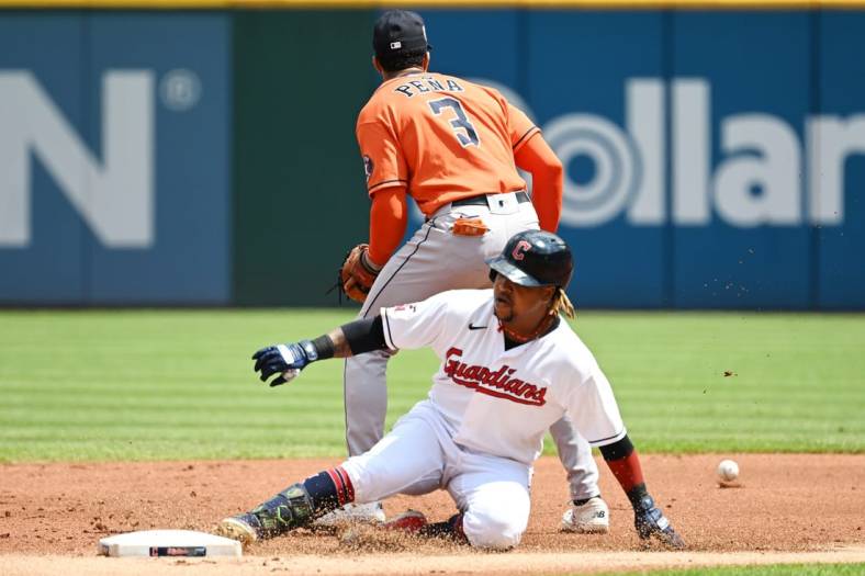 Aug 7, 2022; Cleveland, Ohio, USA; Cleveland Guardians third baseman Jose Ramirez (11) slides into second with a double as Houston Astros shortstop Jeremy Pena (3) waits for the ball during the first inning at Progressive Field. Mandatory Credit: Ken Blaze-USA TODAY Sports