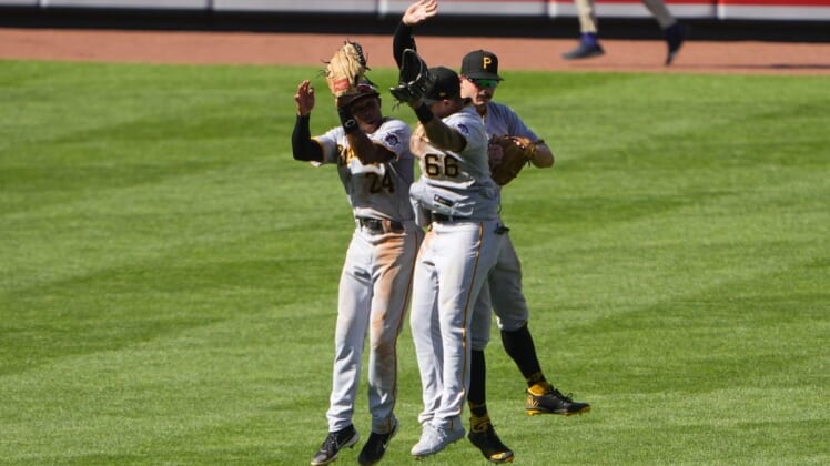 Aug 7, 2022; Baltimore, Maryland, USA; Pittsburgh Pirates left fielder Greg Allen (24) and right fielder Bligh Madris (66) and center fielder Bryan Reynolds (10) celebrate after defeating the Baltimore Orioles at Oriole Park at Camden Yards. Mandatory Credit: Gregory Fisher-USA TODAY Sports