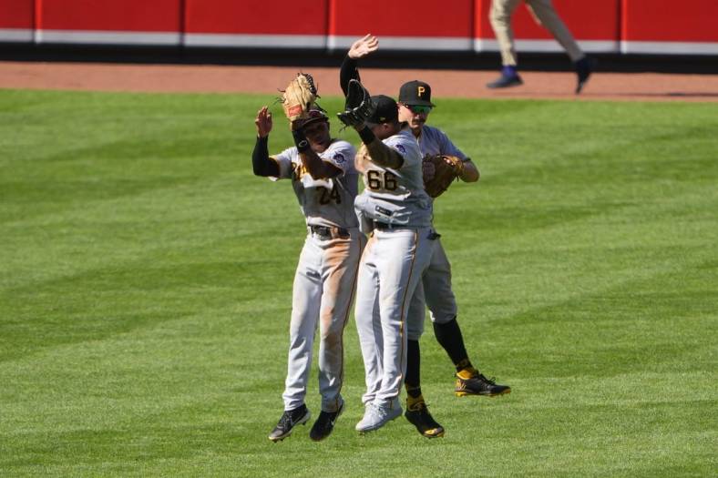 Aug 7, 2022; Baltimore, Maryland, USA; Pittsburgh Pirates left fielder Greg Allen (24) and right fielder Bligh Madris (66) and center fielder Bryan Reynolds (10) celebrate after defeating the Baltimore Orioles at Oriole Park at Camden Yards. Mandatory Credit: Gregory Fisher-USA TODAY Sports