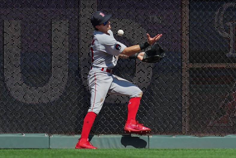 Aug 7, 2022; Kansas City, Missouri, USA; Boston Red Sox center fielder Jarren Duran (40) is unable to make the catch at the wall during the eighth inning against the Kansas City Royals at Kauffman Stadium. Mandatory Credit: Jay Biggerstaff-USA TODAY Sports