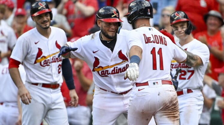 Aug 7, 2022; St. Louis, Missouri, USA;  St. Louis Cardinals shortstop Paul DeJong (11) is congratulated by catcher Yadier Molina (4) after hitting a three run home run against the New York Yankees during the eighth inning at Busch Stadium. Mandatory Credit: Jeff Curry-USA TODAY Sports