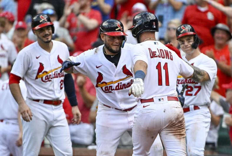 Aug 7, 2022; St. Louis, Missouri, USA;  St. Louis Cardinals shortstop Paul DeJong (11) is congratulated by catcher Yadier Molina (4) after hitting a three run home run against the New York Yankees during the eighth inning at Busch Stadium. Mandatory Credit: Jeff Curry-USA TODAY Sports