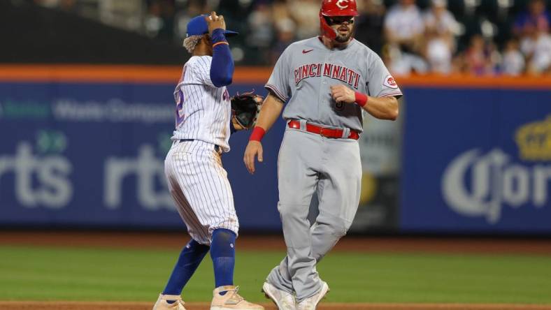 Aug 8, 2022; New York City, New York, USA; Cincinnati Reds first baseman Mike Moustakas (9) is out at second base by New York Mets shortstop Francisco Lindor (12) during the fourth inning at Citi Field. Mandatory Credit: Vincent Carchietta-USA TODAY Sports