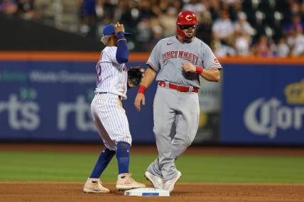 Aug 8, 2022; New York City, New York, USA; Cincinnati Reds first baseman Mike Moustakas (9) is out at second base by New York Mets shortstop Francisco Lindor (12) during the fourth inning at Citi Field. Mandatory Credit: Vincent Carchietta-USA TODAY Sports