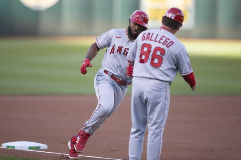 Aug 8, 2022; Oakland, California, USA; Los Angeles Angels second baseman Luis Rengifo (left) is greeted by third base coach Mike Gallego (86) after hitting a solo home run during the first inning at RingCentral Coliseum. Mandatory Credit: D. Ross Cameron-USA TODAY Sports