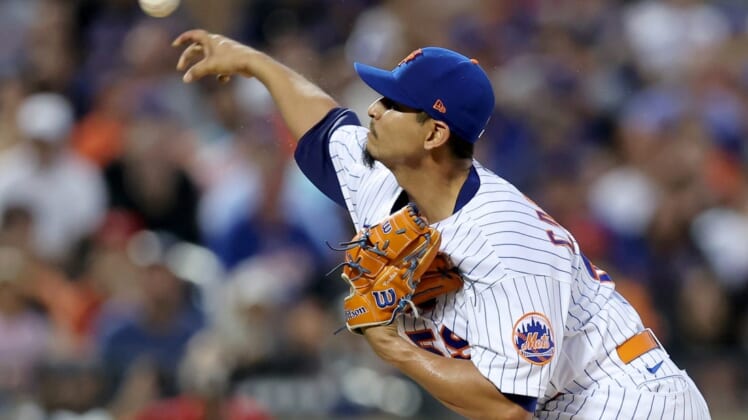 Aug 9, 2022; New York City, New York, USA; New York Mets starting pitcher Carlos Carrasco (59) pitches against the Cincinnati Reds during the first inning at Citi Field. Mandatory Credit: Brad Penner-USA TODAY Sports