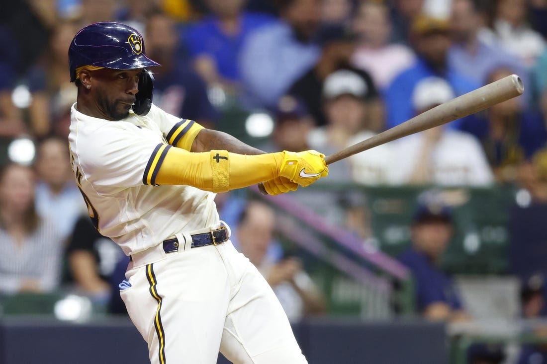 Aug 9, 2022; Milwaukee, Wisconsin, USA;  Milwaukee Brewers designated hitter Andrew McCutchen (24) hits an RBI single during the fifth inning against the Tampa Bay Rays at American Family Field. Mandatory Credit: Jeff Hanisch-USA TODAY Sports