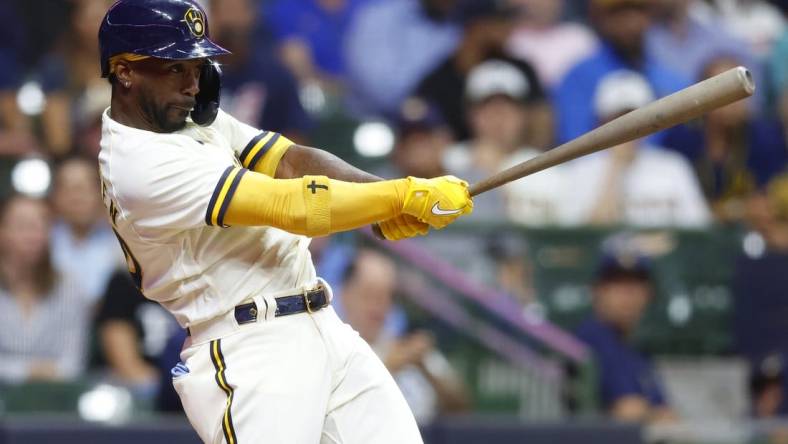 Aug 9, 2022; Milwaukee, Wisconsin, USA;  Milwaukee Brewers designated hitter Andrew McCutchen (24) hits an RBI single during the fifth inning against the Tampa Bay Rays at American Family Field. Mandatory Credit: Jeff Hanisch-USA TODAY Sports