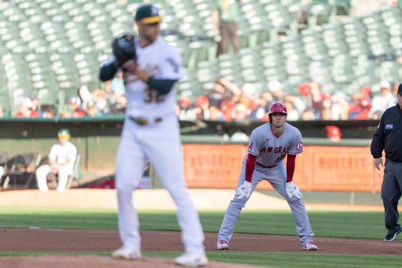 Aug 9, 2022; Oakland, California, USA;  Los Angeles Angels starting pitcher Shohei Ohtani (17) watches Oakland Athletics starting pitcher James Kaprielian (32) during the first inning at RingCentral Coliseum. Mandatory Credit: Stan Szeto-USA TODAY Sports