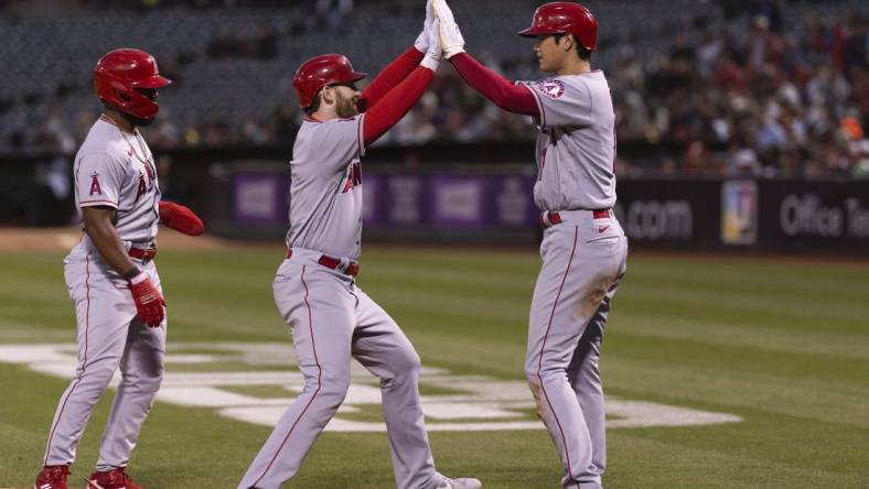 Aug 9, 2022; Oakland, California, USA;  Los Angeles Angels starting pitcher Shohei Ohtani (17) celebrates with Los Angeles Angels right fielder Taylor Ward (3) after hitting a three run homerun during the fifth inning against the Oakland Athletics at RingCentral Coliseum. Mandatory Credit: Stan Szeto-USA TODAY Sports