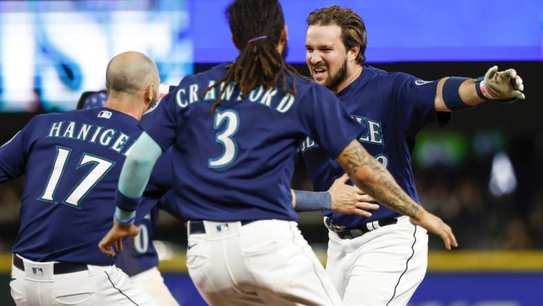 Aug 9, 2022; Seattle, Washington, USA; Seattle Mariners pinch hitter Luis Torrens (22) celebrates after hitting a walk-off RBI-single against the New York Yankees during the thirteenth inning at T-Mobile Park. Seattle defeated New York, 1-0. Mandatory Credit: Joe Nicholson-USA TODAY Sports