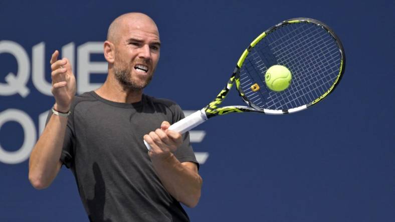 Aug 10, 2022; Montreal, QC, Canada; Adrian Mannarino (FRA) hits a forehand against Jannik Sinner (ITA) (not pictured) in second round play at IGA Stadium. Mandatory Credit: Eric Bolte-USA TODAY Sports