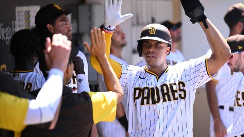 Aug 10, 2022; San Diego, California, USA; San Diego Padres right fielder Juan Soto (right) is congratulated in the dugout after scoring a run on a single hit by designated hitter Brandon Drury (17) during the third inning against the San Francisco Giants at Petco Park. Mandatory Credit: Orlando Ramirez-USA TODAY Sports