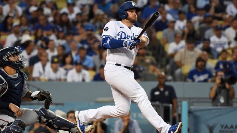 Aug 10, 2022; Los Angeles, California, USA; Los Angeles Dodgers third baseman Max Muncy (13) hits a solo home run in the second inning against the Minnesota Twins at Dodger Stadium. Mandatory Credit: Richard Mackson-USA TODAY Sports